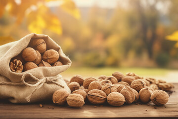 Walnuts in burlap sack on wooden surface. Sack full of nuts prepared for easy snack bag. Consuming local commerce in small businesses and cooperatives that produce organic foods. - obrazy, fototapety, plakaty