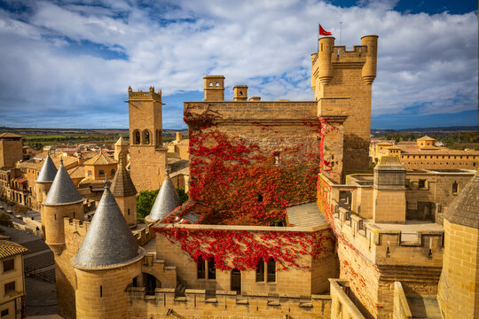 View of the Olite castle and palace in Navarra, Spain, with its slender towers and the red vine that climbs its walls