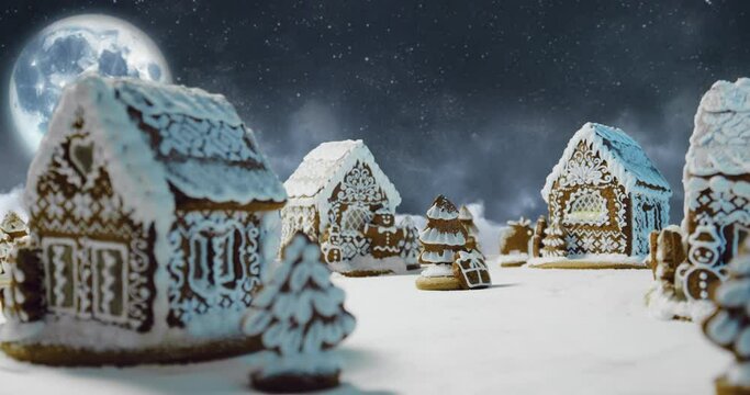 Magic Christmas night scene with gingerbread village. Big moon and moving clouds around