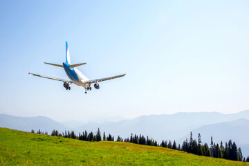 passenger plane flies over a mountain valley. air transport industry