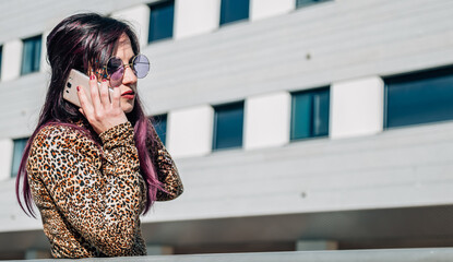 Fototapeta premium retro young woman talking with mobile phone on the street