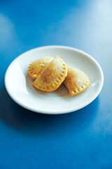 plate of dumplings on blue background