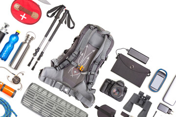 Set of tourist trekking items on white background. Top view of accessories for travel. Equipment for travel and hiking. Survival Items.