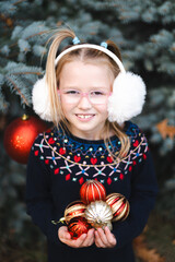 girl with basket full of christmas red balls