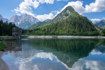 Fototapeta na wymiar Lake called Jasna in European Slovenian Julian Alps, beautiful water surface with reflections near the road to Vrsic Pass