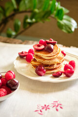 Pancakes withberries on a white napkin. Side view. Fritters.