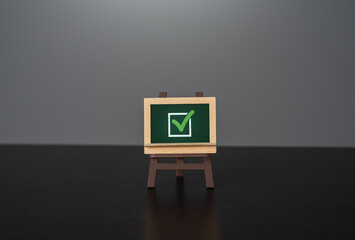 Chalk board with green check mark. Election concept. Voting and politics. Removing restrictions and granting permits. Fulfill all requirements. Reach the goal. - obrazy, fototapety, plakaty