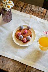 Pancakes withberries on a white napkin. Side view. Fritters.