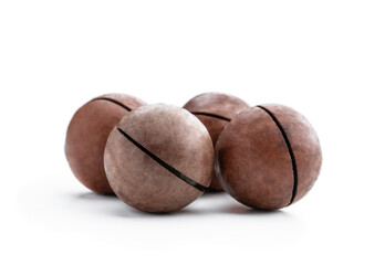 Unpeeled macadamia nut isolated on white background