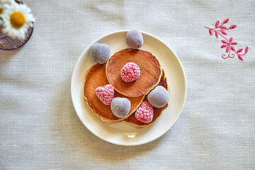Pancakes withberries on a white napkin. Top view. Fritters.