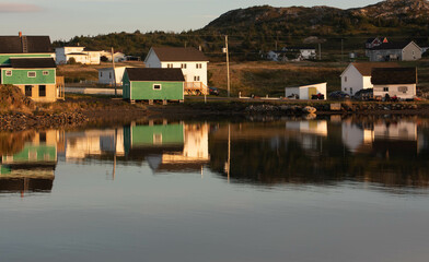fishing shack reflecting on the water in Newfoundland