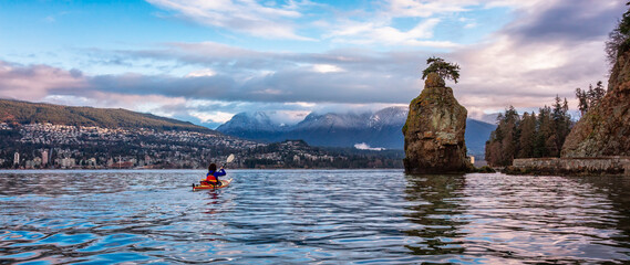 Kayaking at Seawall in Stanley Park. Cloudy Sunrise in Winter. Downtown Vancouver
