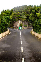 A forked or Y-intersection or junction where you have to turn right. A road in the mountains on Santa Cruz de Tenerife, Spain. 