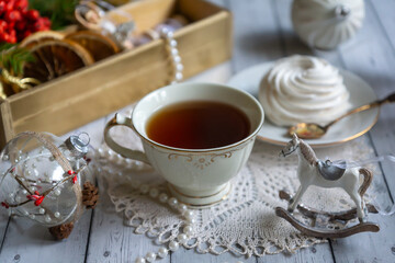 A cup of tea, New Year's toys, a calendar for the New Year 2024. Still life in vintage style.