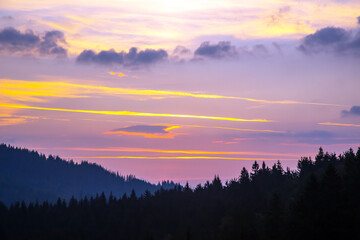 brightly colorful clouds in the evening sky. Lush colored clouds in the sky before sunset