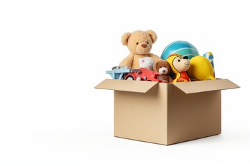 Cardboard box with toys and teddy, white background