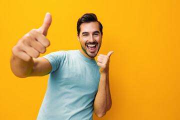 Man portrait studio background gesture style lifestyle copy yellow space trendy smiling arm fashion laughing - obrazy, fototapety, plakaty