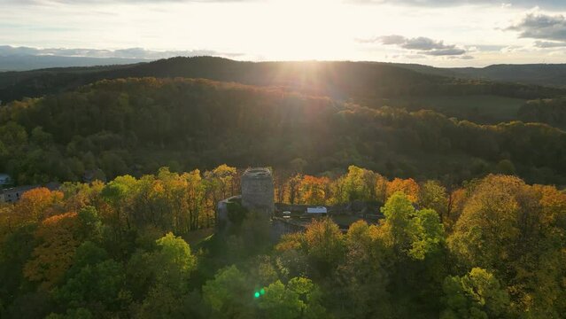 An aerial view of the beautiful ruins of Wlen Castle, in the town of Wlen, Lower Silesia in Poland, at the foot of the Karkonosze Mountains on the Bobr River, in autumn just before sunset.