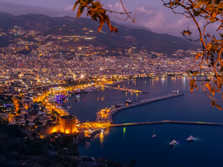 Naklejka premium View from Alanya castle to the harbor at night, city lights at evening, Night Photography.