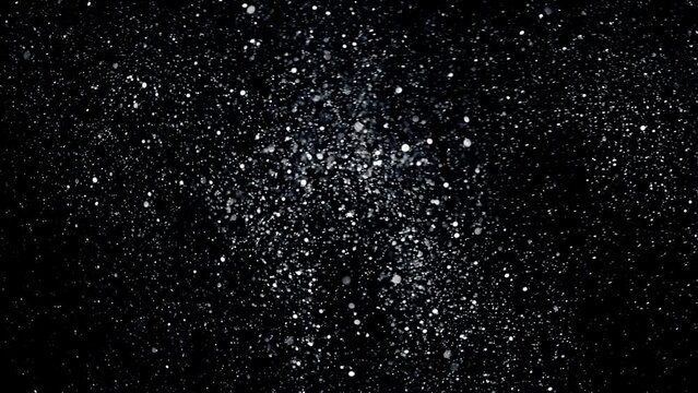4K Multicolored abstract glitter particles. Shimmering Particles Falling glitter with glare on a bokeh background. Titles in awards, music, wedding, anniversary, party, and presentation backdrops.