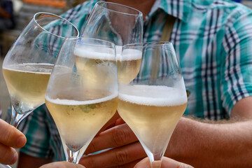 Tasting of sparkling white wine with bubbles champagne on summer festival route of champagne in Cote des Bar, Champagne region, France