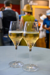 Tasting of sparkling white wine with bubbles champagne on summer festival route of champagne in Cote des Bar, Champagne region, France