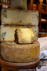Different Asturian cheeses made from cow, goat and sheep melk on display in farmers cheese shop, Asturias, North Spain