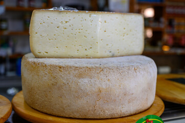 Different Asturian cheeses made from cow, goat and sheep melk on display in farmers cheese shop,...