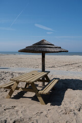 Beach holidays on sandy beach, waterfront relaxation with sun umbrella in Katwijk-on-zee, North sea, Netherlands