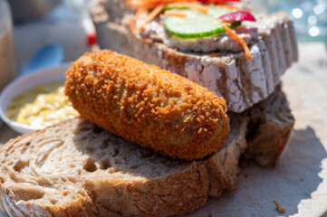 Fototapeta na wymiar Dutch fast food, deep fried croquettes filled with ground beef meat served on bread