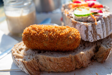 Fototapeta na wymiar Dutch fast food, deep fried croquettes filled with ground beef meat served on bread