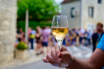 Tasting of sparkling white wine with bubbles champagne on summer festival route of champagne in...
