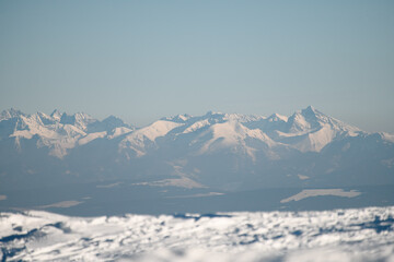 Fototapeta na wymiar Amazing view of mountain peaks covered with snow. Snowy mountains in winter day