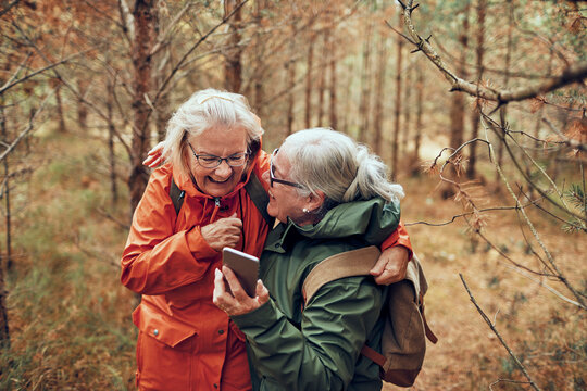 Two senior women walking in nature