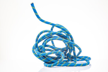 durable colored rope for climbing equipment on a white background. climbing rope. coil of braided cable. item for tourism and travel