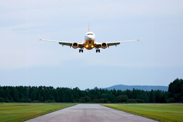 passenger plane flies over the runway. air transport industry