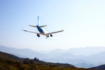 Fototapeta na wymiar passenger plane flies over a mountain valley. air transport industry