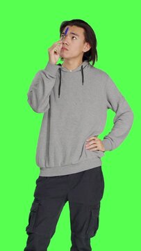 Front view of male thinker acting confused on camera, thinking about question and putting his focus on new perspective. Person being uncertain and pensive, pondering solution over greenscreen.