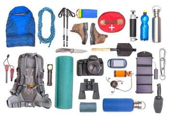 Set of tourist trekking items on white background. Top view of accessories for travel. Equipment...