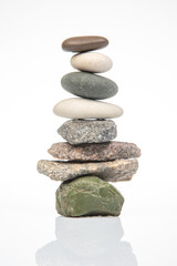 Fototapeta na wymiar pyramid of stacked stones on a white background. stabilization and balance in life