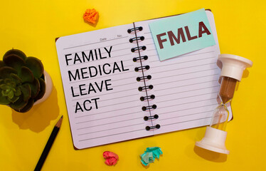 Family And Medical Leave Act FMLA written on notebook with stethoscope, syringe and pills.