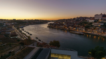 View from Vila Nova de Gaia Jardim do Morro over old town at Cais da Ribeira during golden hour in the evening in Porto, Portugal