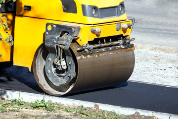 asphalt roller at work repairing a road for pedestrians