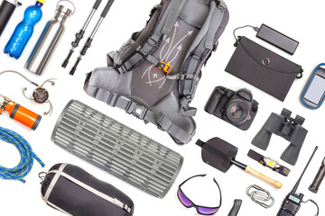 Set of tourist trekking items on white background. Top view of accessories for travel. Equipment...