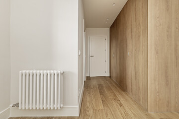 Hallway to a bedroom with fitted wardrobes with custom made light oak doors with access to an...