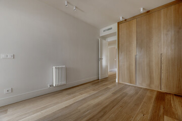 bedroom with built-in wardrobes with custom-made light oak doors, cast iron radiator, white painted...