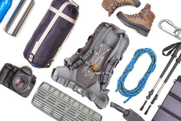 Set of tourist trekking items on white background. Top view of accessories for travel. Equipment for travel and hiking. Survival Items.