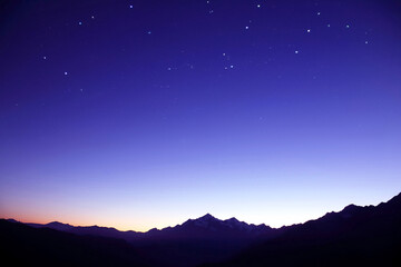 the starry sky in the mountains before the morning dawn. astronomy and planetary observation