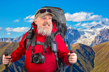 happy bearded man traveler with hiking equipment against the backdrop of a mountain landscape. travel, hiking and adventure
