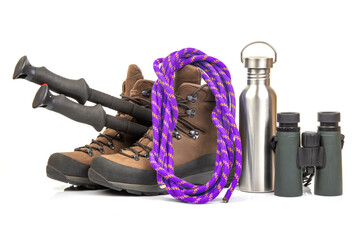 Items for tourism and hiking near trekking boots on a white background. set of equipment for tourism and travel